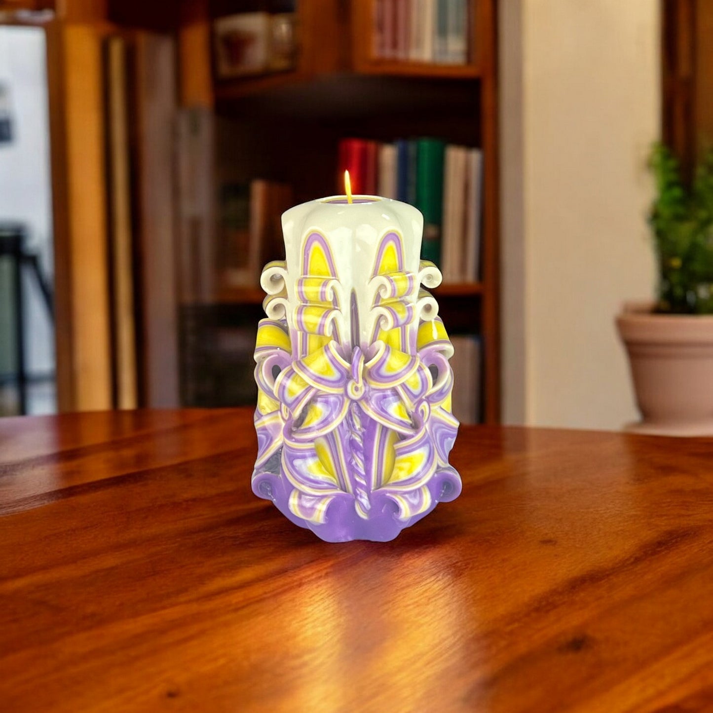 A multicolored candle predominantly yellow with accents of purple.
Used for romantic dinner, wedding, proposal, baptazing event.