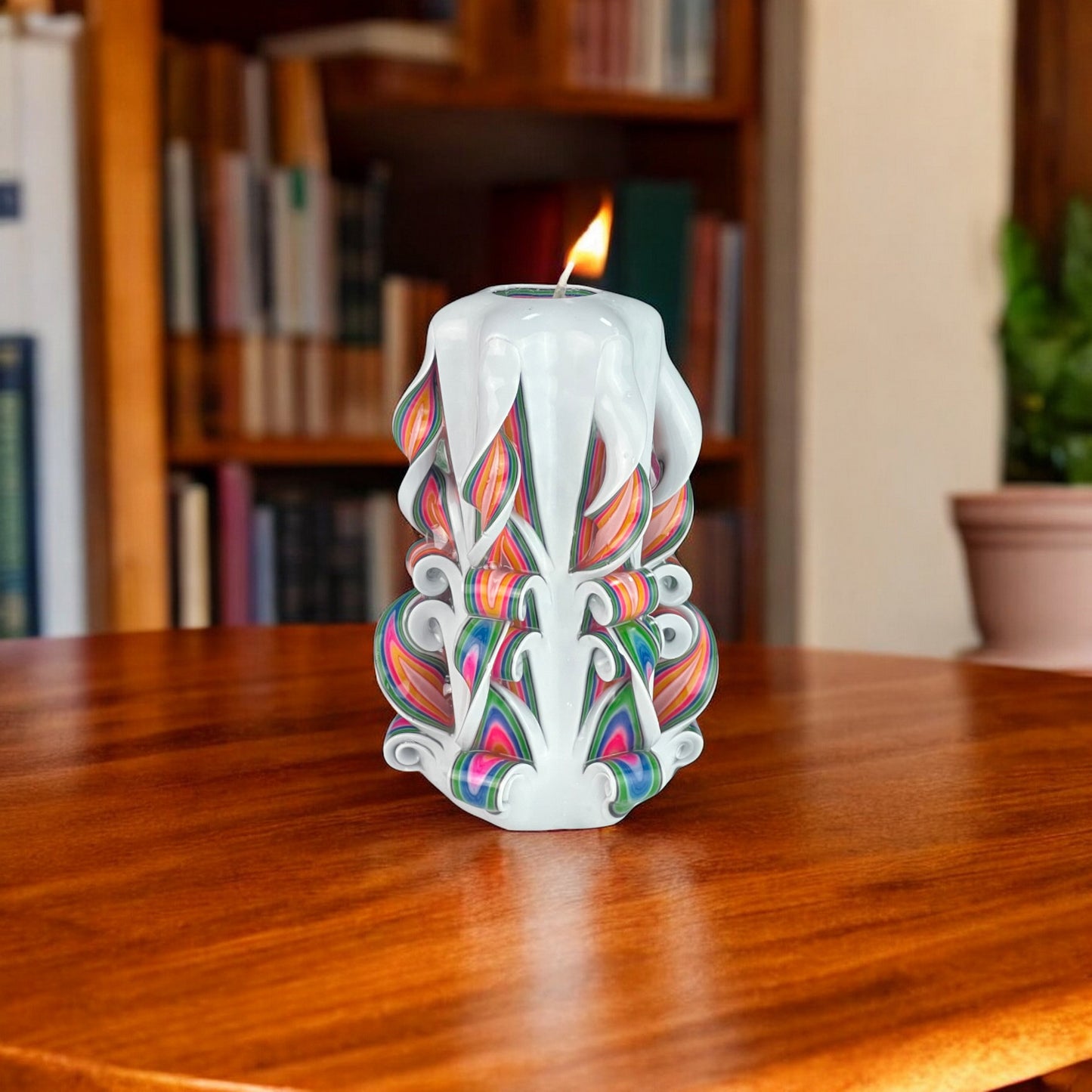 A multicolored candle with a rainbow-like pattern, predominantly white with accents of red, green, and blue.
Used for romantic dinner, wedding, proposal, baptazing event.