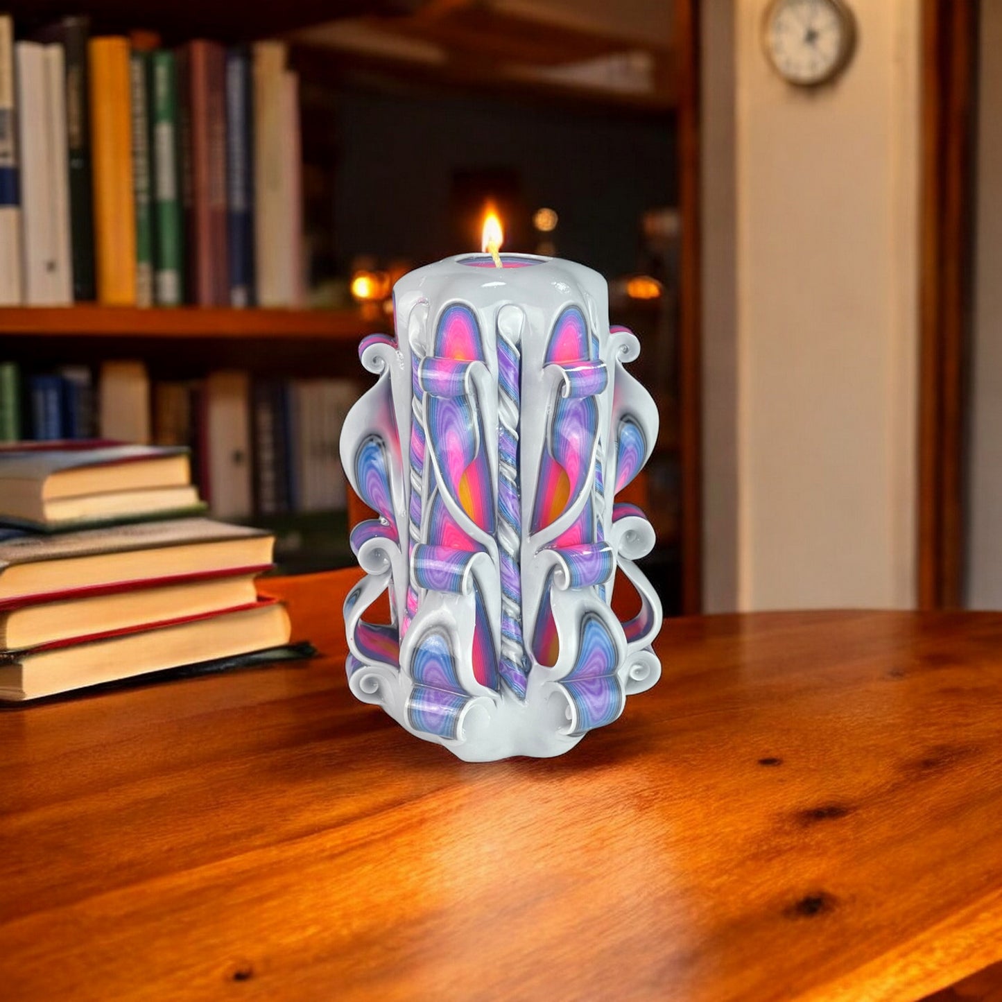 A decorative candle with a design resembling a sunset in shades of purple, blue, and pink.
Used for weddings, proposals, baptazing events.