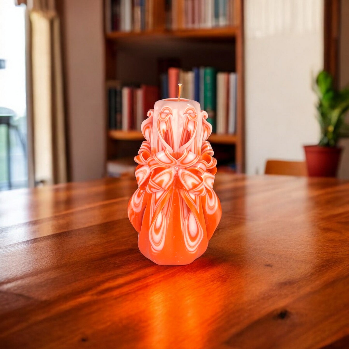An orange candle with a swirling pattern, resembling a citrus fruit, with a visible wick.
Used for romantic dinner, wedding, proposal, baptazing event.