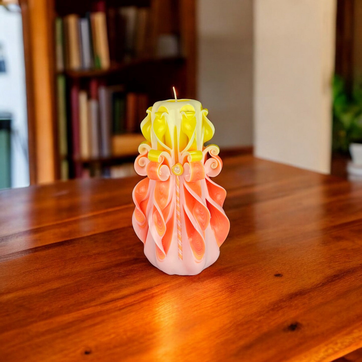 A multicolored candle with a decorative top that resembles a floral pattern in orange, yellow, and white, with a single wick.
Used for romantic dinner, wedding, proposal, baptazing event.