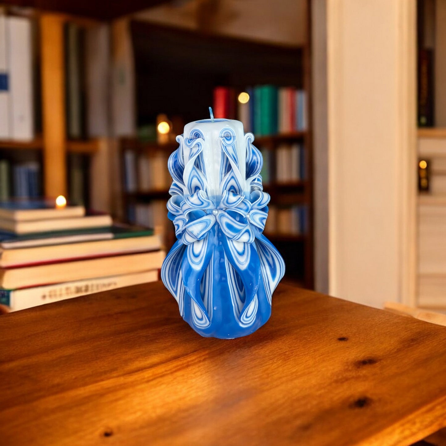 Deep Lake Candle 500g
A blue and white patterned candle with a decorative top and a lit wick.