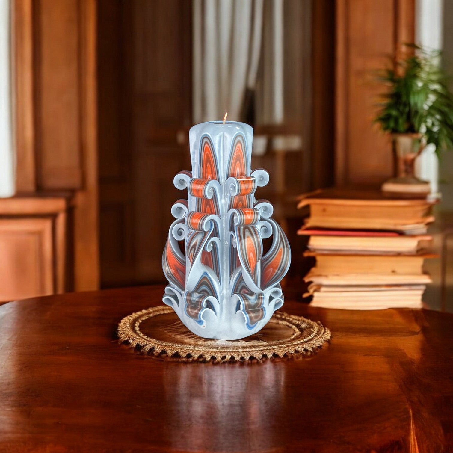A decorative candle with a design resembling a mermaid's tail in shades of blue, orange, and brown.
Used for weddings, proposals, baptazing events.