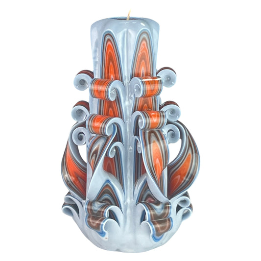 A decorative candle with a design resembling a mermaid's tail in shades of blue, orange, and brown.
Used for weddings, proposals, baptazing events.
