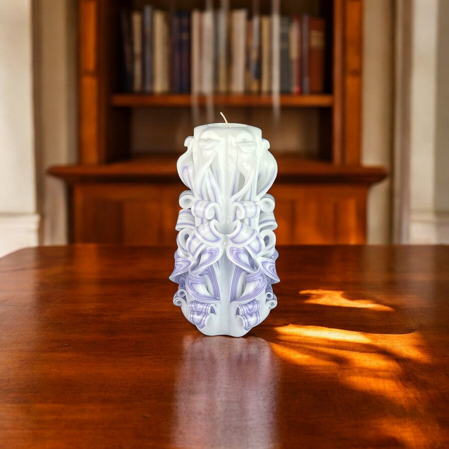 Velvet Candle 950g
A tall, elegant candle with a smooth, velvety white upper section and a textured black base, with intricate designs and swirls.